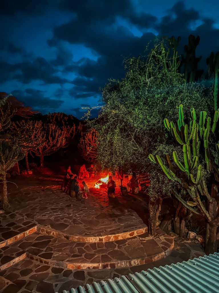 People singing Maasai songs at a fireside in Maji Moto Maasai Cultural Camp