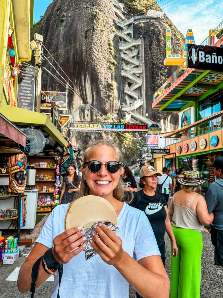 Best Things To Do in Guatape - Eating a Snack in front of El Penol Rock in Guatape, Colombia