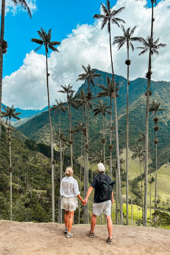 Best Things To Do in Salento - Visit the Valle de Cocora - Couple standing in front of tall Palm trees