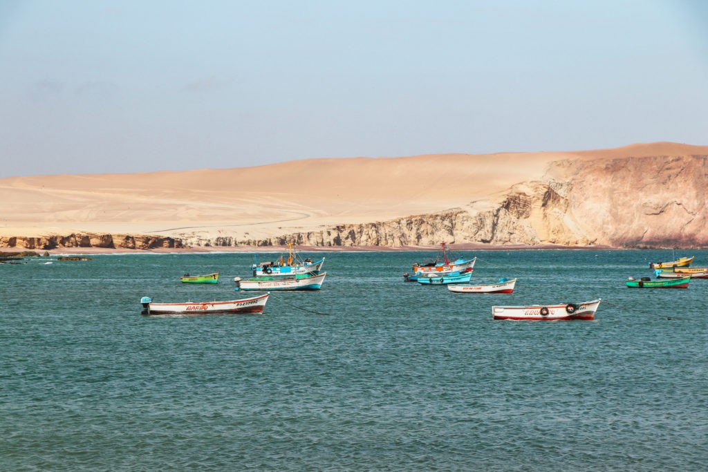 Paracas National Reserve Guide - Colorful boats on the sea near the fishermen harbor Lagunillas