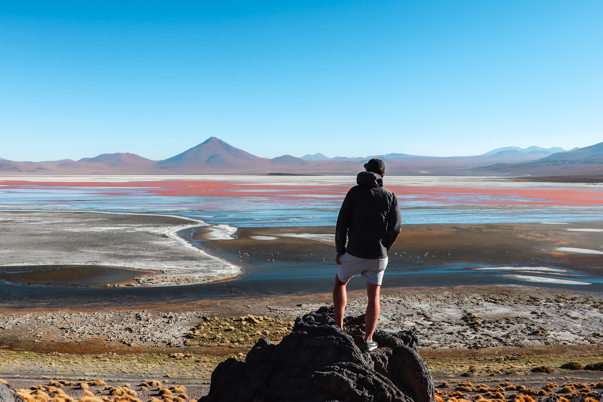 Uyuni Travel Guide: Enjoying the spectacular view over the Laguna Colorada in the Reserve Nacional de Fauna Andina Eduardo Avaroa in Bolivia