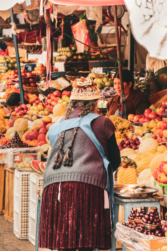 Best Things to Do in Sucre, Bolivia: Bolivian cholita buying fruits at the market