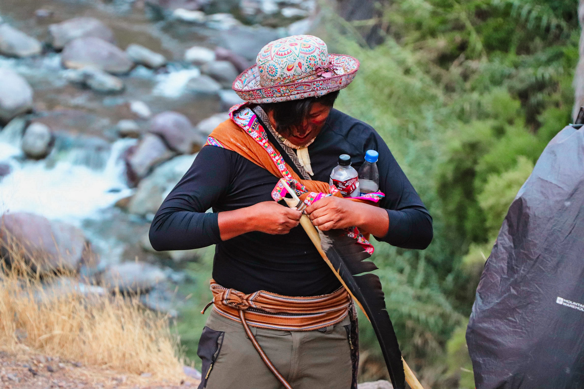 How to avoid altitude sickness in Peru: Peruvian tour guide holding a feather of a condor